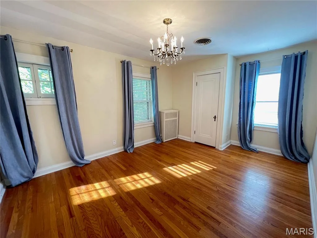 Bedroom with chandelier and draperies