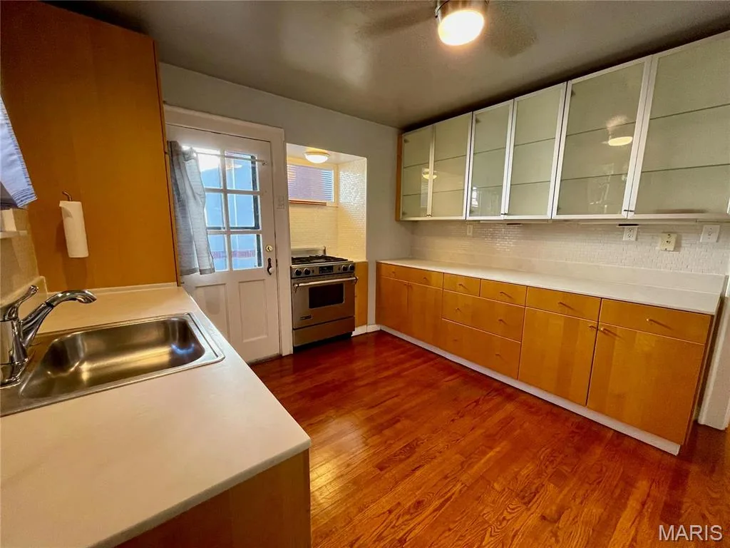 Kitchen with sink and wood cabinetry