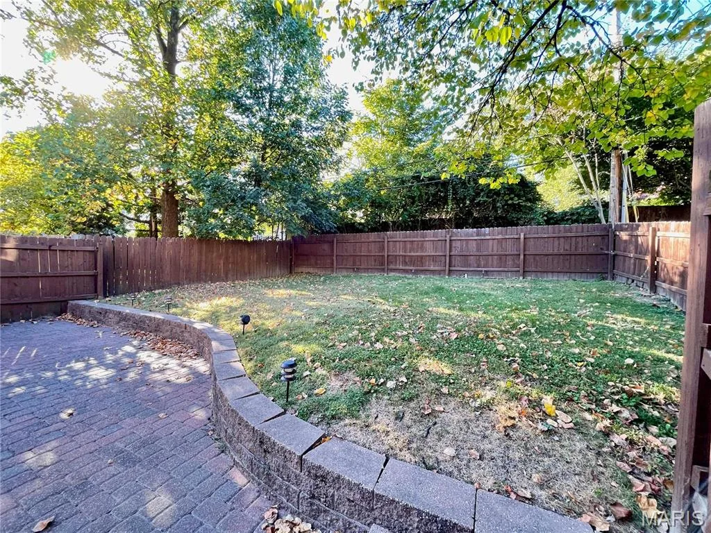 Fenced backyard lawn