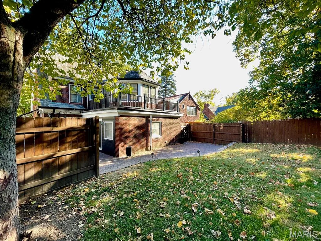 Fenced backyard with deck